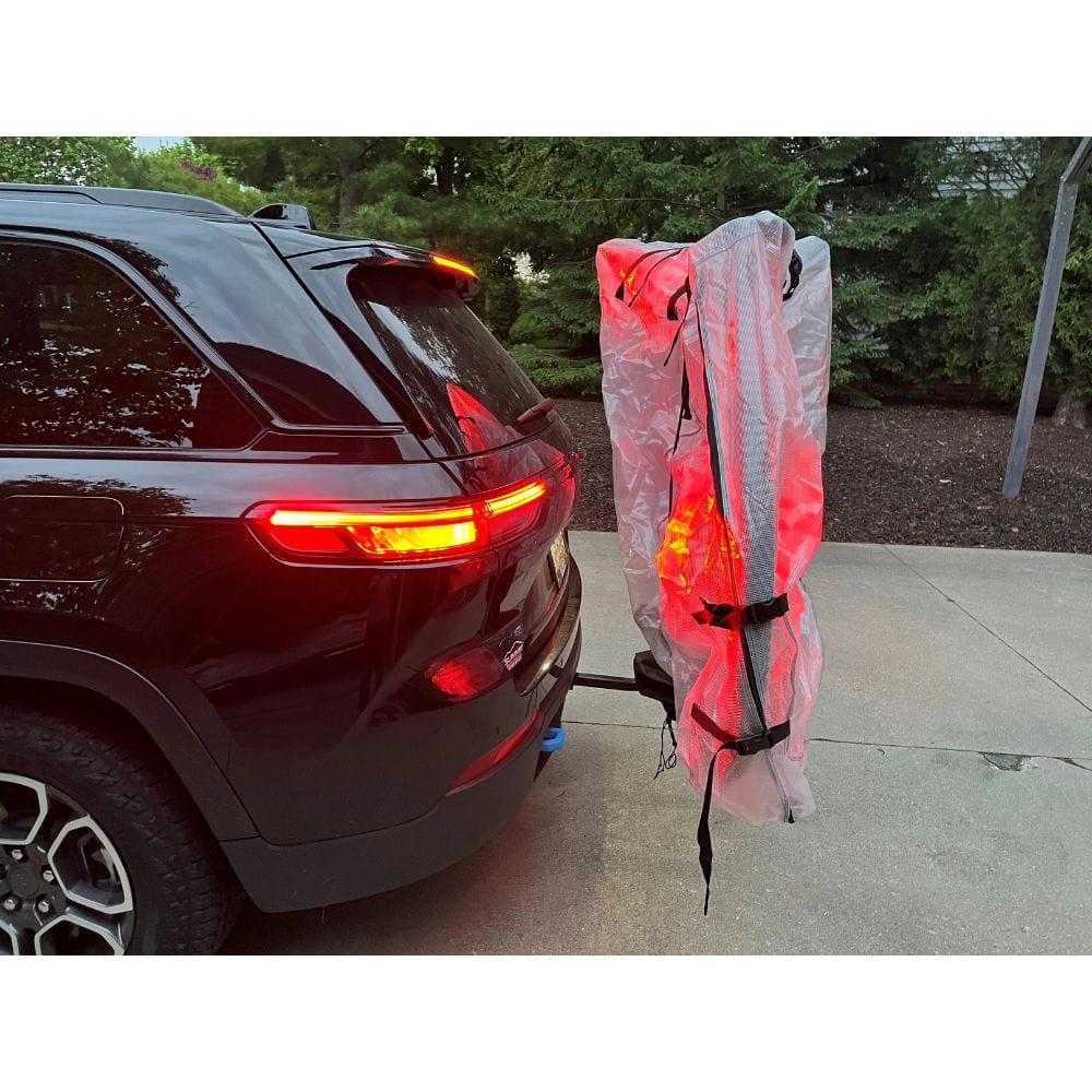 Car with a kayak attached to its back, ready for transport.