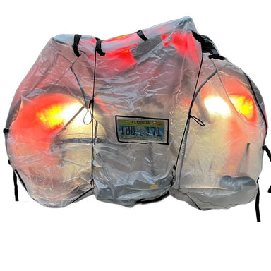 Covered motorcycle with glowing lights on a white background