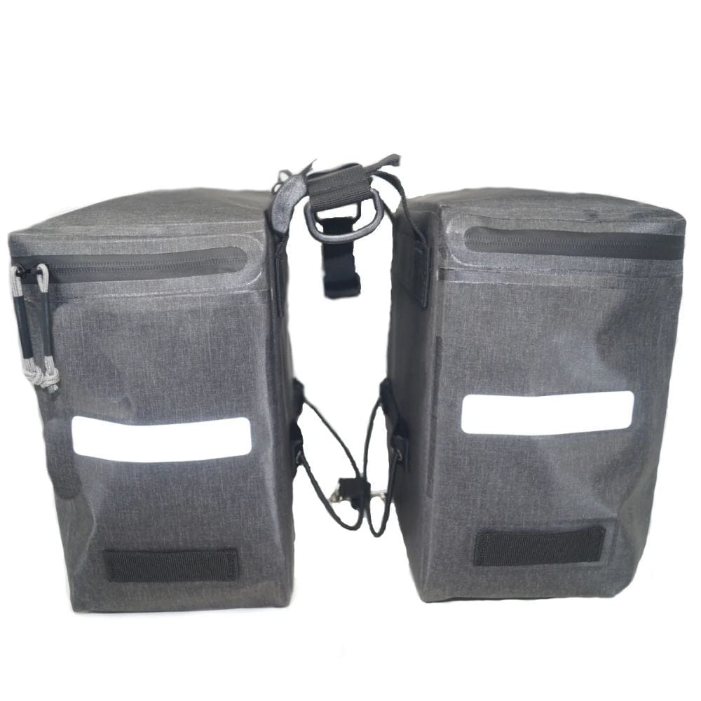 Pair of gray bike panniers with reflective strips on a white background