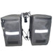 Pair of gray bike panniers with reflective strips on a white background