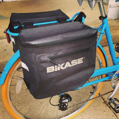 Bikase bike bag attached to a blue bicycle with orange tires.