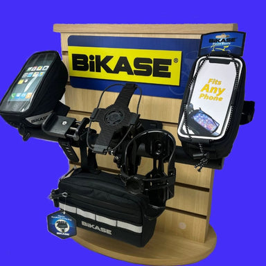 Bikase phone holder display with multiple phone holders on a wooden stand against a blue background.