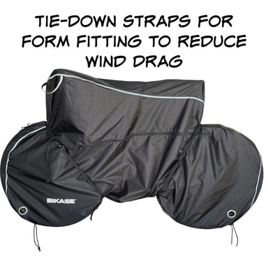 Black bike cover with tie-down straps for reducing wind drag, featuring the BIKASE brand.